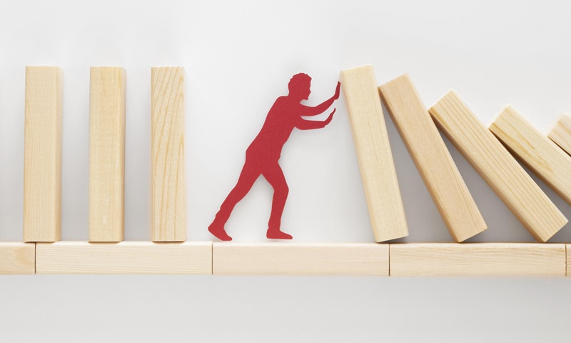 abstract-representation-financial-crisis-with-wooden-pieces-71815416.jpg