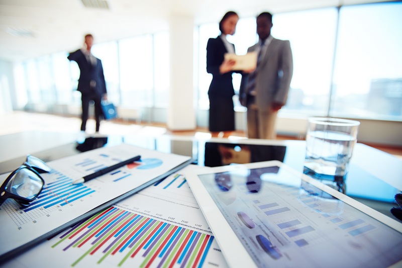 close-up-financial-report-with-businesspeople-background-7431716.jpg
